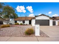 Charming single-story home with a well-maintained xeriscaped front yard and a two-car garage at 1002 E Grandview Rd, Phoenix, AZ 85022