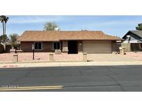 Charming single-story home with a well-maintained yard and attached two-car garage at 10250 N 65Th N Ave, Glendale, AZ 85302