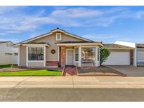 Charming single-story home with beige siding, brick accents, and a well-manicured front yard at 129 E Campo Bello Dr, Phoenix, AZ 85022