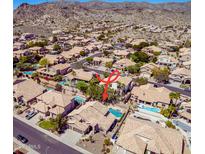 Expansive aerial view of desert neighborhood featuring tile roofs, mature landscaping, and sparkling private pools in backyard retreats at 2108 E Tecoma Rd, Phoenix, AZ 85048