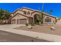 Beautiful two-story home featuring a tile roof, desert landscaping, and a three-car garage at 2108 E Tecoma Rd, Phoenix, AZ 85048