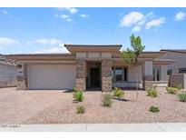 Charming single-story home with stone accents, low maintenance desert landscaping, and a two car garage at 21539 S 191St Pl, Queen Creek, AZ 85140