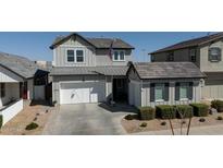 Charming two-story home with a two car garage, a well-kept lawn and an American flag at 22752 E Arroyo Verde Dr, Queen Creek, AZ 85142