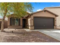 Charming single-story home featuring a low-maintenance front yard and a two-car garage at 35730 N Pommel Pl, San Tan Valley, AZ 85144