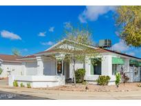 Charming single-story home with white exterior, desert landscaping, and bright blue sky at 502 W Beverly Ln, Phoenix, AZ 85023