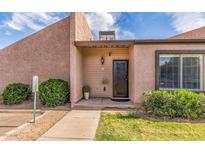 Inviting front entrance with a secure screen door and well-maintained landscaping at 629 N Mesa Dr # 18, Mesa, AZ 85201
