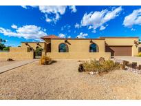 Beautiful single-story home showcasing a well-kept yard, brown trim, and attached garage at 7656 W Wagoner Rd, Glendale, AZ 85308