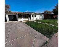 Charming single-story home with well-maintained lawn, neutral exterior, and concrete driveway at 1017 S Lola Ln, Tempe, AZ 85281