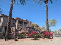 Beautiful condo complex entrance with desert landscaping, stone signage, and well-maintained facade at 14000 N 94Th St # 3147, Scottsdale, AZ 85260