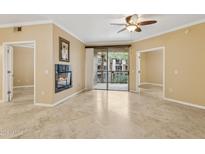 Bright living room with fireplace, ceiling fan, and sliding doors to a balcony at 1701 E Colter St # 311, Phoenix, AZ 85016