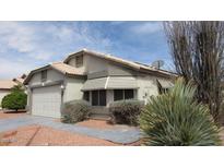 Charming single-story home with desert landscaping, light stucco, and a two-car garage at 20479 N 105Th Ave, Peoria, AZ 85382