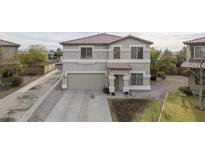 Charming two-story home featuring an attached two-car garage and low maintenance landscaping at 30419 N Plantation Dr, San Tan Valley, AZ 85143