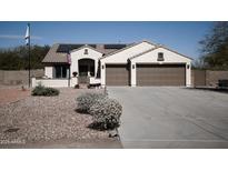 Charming single-story home featuring a well-manicured desert landscape and two-car garage at 3721 N Brindley Ave, Litchfield Park, AZ 85340