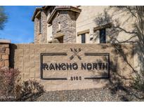 Welcoming Rancho North community sign with stone accents and black lettering showcasing the neighborhood's entrance at 5100 E Rancho Paloma Dr # 2061, Cave Creek, AZ 85331