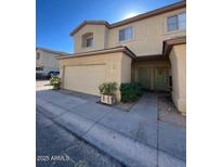 Charming townhouse with a two-car garage and welcoming front entrance with beautiful desert landscaping at 15655 N 29Th St, Phoenix, AZ 85032
