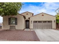 Charming single-story home with desert landscaping, private entry, and a two car garage at 16268 W Cortez St, Surprise, AZ 85379