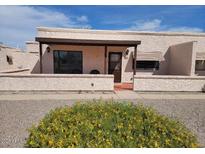 Charming single-story home with well-maintained landscaping and inviting front entrance at 311 E Lancaster Ct, Florence, AZ 85132