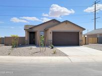 Charming single-story home with a desert-landscaped front yard and a two-car garage at 318 S San Fernando Ln, Casa Grande, AZ 85194