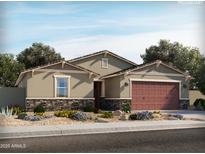 Inviting single-story home with charming stone accents and a well-manicured front yard at 345 S Alegria Ln, Casa Grande, AZ 85194