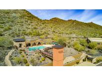 Community pool area with mountain views, seating, and a covered pavilion in a desert landscape at 36600 N Cave Creek Rd # 17D, Cave Creek, AZ 85331