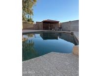 Backyard swimming pool with safety fence and covered structure at 5430 N 74Th Ave, Glendale, AZ 85303