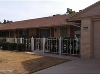 Charming single-story home featuring well-kept landscaping and a welcoming facade at 10327 W Prairie Hills Cir, Sun City, AZ 85351