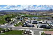 Scenic aerial view of a residential home near a golf course, pond, and mountain backdrop, highlighting community amenities at 11878 N Hershey St, Surprise, AZ 85388