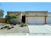 Charming home featuring a two-car garage, desert landscaping, and a lovely tiled roof at 16857 E Deuce Ct, Fountain Hills, AZ 85268