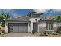 Modern prairie-style home featuring a two-car garage, decorative brick, and clerestory above the entry at 21450 W Meadowbrook Ave, Buckeye, AZ 85396