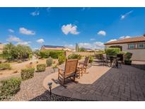 Charming backyard patio with seating and landscaping, ideal for relaxing outdoors and enjoying the views at 37036 N Stoneware Dr, Queen Creek, AZ 85140