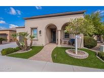 Charming front exterior with stucco, well-manicured landscaping, and a welcoming covered entrance at 37036 N Stoneware Dr, Queen Creek, AZ 85140