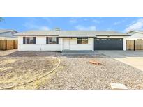 Charming single-story home featuring a well-maintained gravel yard, attached garage, and a cozy front porch at 4207 W Poinsettia Dr, Phoenix, AZ 85029