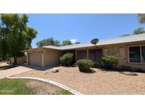 Tan single story home with low maintenance desert landscaping and attached two car garage at 4773 E Hopi St, Phoenix, AZ 85044