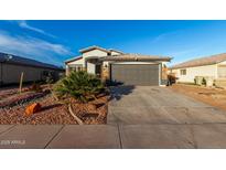 Charming single-story home showcasing a well-kept front yard and two car garage at 5361 N 77Th Ln, Glendale, AZ 85303