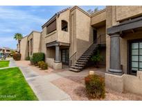 Inviting condo exterior featuring desert landscaping, two-story layout and convenient stair access to the upper units at 5995 N 78Th St # 1053, Scottsdale, AZ 85250