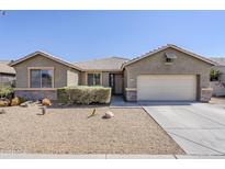 Inviting single-story home featuring a low-maintenance desert landscape and attached two-car garage at 6615 S 25Th Dr, Phoenix, AZ 85041