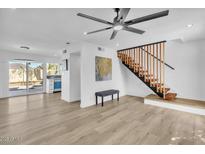 Bright living room with modern finishes, light wood floors, and stylish staircase at 930 W Mission Ln, Phoenix, AZ 85021