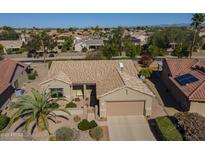 Charming single-story home features a tile roof, desert landscaping, and an attached two-car garage at 19746 N Wind Rose Way, Surprise, AZ 85374