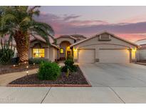 Charming single-story home featuring a well-manicured yard, desert landscaping, and a spacious three-car garage at 2328 N 123Rd Ln, Avondale, AZ 85392