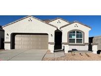 Single-story home featuring a neutral color scheme, complemented by a convenient two-car garage at 25436 W Graham Trl, Buckeye, AZ 85326