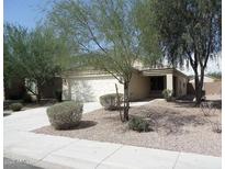 Charming single-story home with mature landscaping, a two car garage and a welcoming front entrance at 43818 W Arizona Ave, Maricopa, AZ 85138