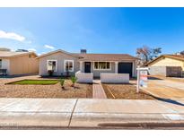 Charming single-story home with well-maintained landscaping, fresh paint, and a covered entryway at 4449 W Turquoise Ave, Glendale, AZ 85302