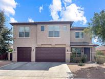 Two-story home featuring a three-car garage and neutral exterior at 45717 W Ranch Rd, Maricopa, AZ 85139