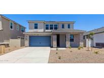 Charming two-story home featuring stone accents, neutral colors, and a well-maintained front yard at 7436 W Buckhorn Trl, Peoria, AZ 85383