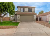 Two-story home with a large garage and well-maintained lawn at 927 E Baylor Ln, Gilbert, AZ 85296