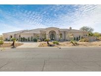 Charming single-story home with desert landscaping, circular driveway, and arched windows at 9826 N 131St St, Scottsdale, AZ 85259