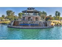 A beautiful stone Layton Lakes entrance with a waterfall and gazebo overlooks the lake and greets residents and visitors at 1163 E Holbrook St, Gilbert, AZ 85298