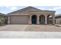 Charming single-story home featuring a welcoming arched entryway and a two-car garage at 13512 W Copperleaf Ln, Peoria, AZ 85383