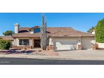 Charming single-story home featuring a low-pitched roof and three-car garage with desert landscaping at 1816 N Salem St, Mesa, AZ 85205