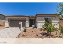 Charming single-story home featuring a two-car garage and low maintenance desert landscaping at 23805 N 163Rd Dr, Surprise, AZ 85387
